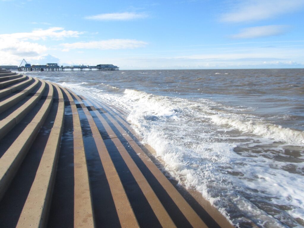 Waves trickling up the steps at Blackpool promenade